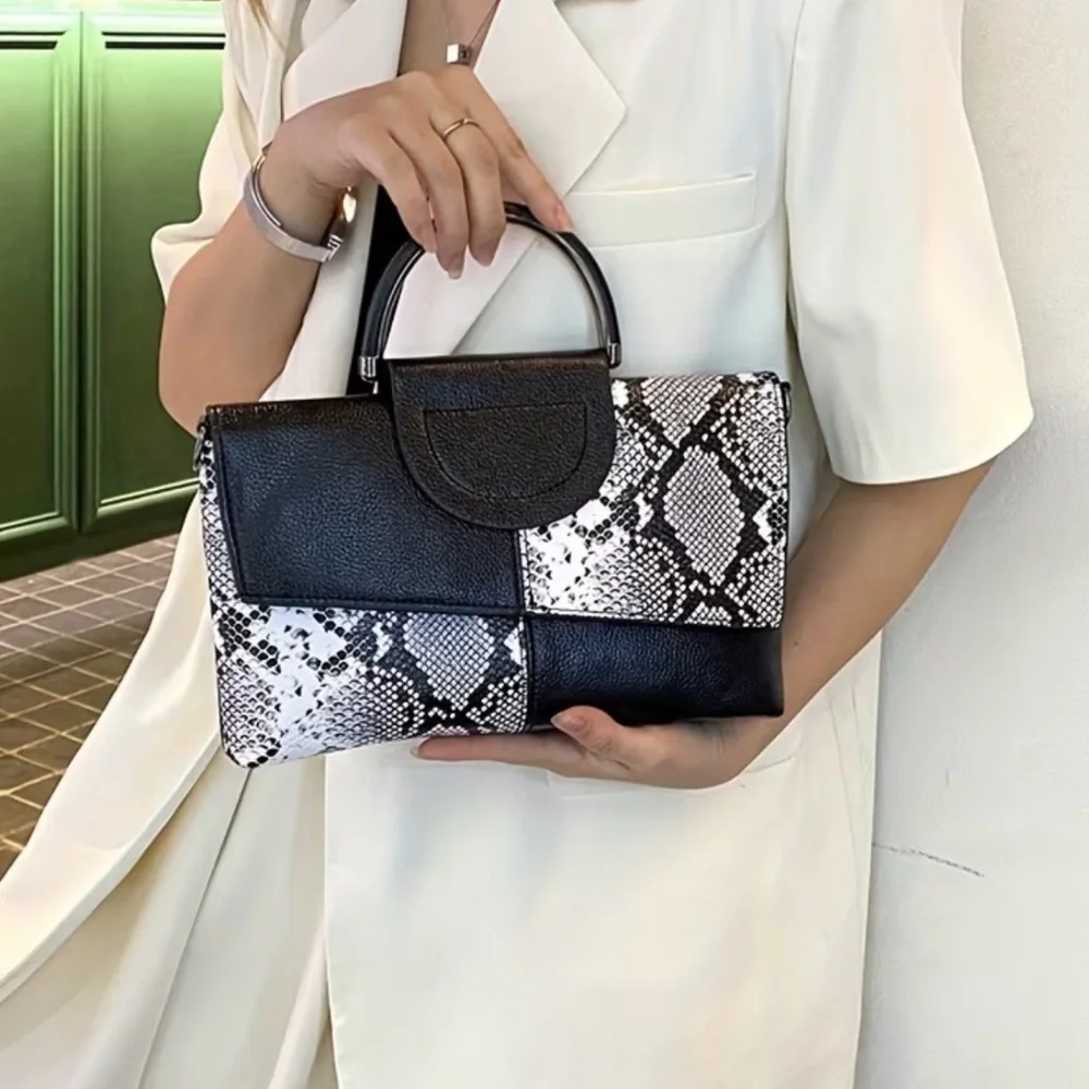 Luce black and white snakeskin clutch bag